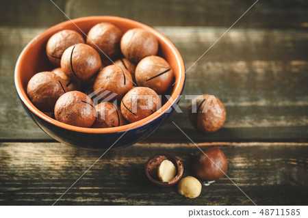 Macadamia nuts on wooden table 48711585