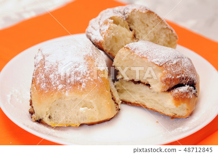 broken bun on a white plate broken bun on a white plate 48712845