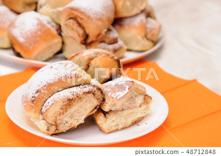 broken bun on a white plate 48712848