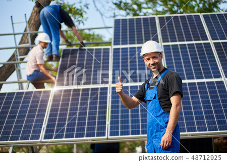 Stand-alone exterior solar panel system installation, renewable green energy generation concept. Stand-alone exterior solar panel system installation, renewable green energy generation concept. 48712925