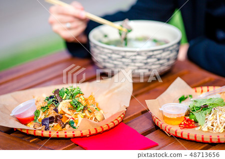 Asian rice noodles with vegetables and sause close-up on the table Asian rice noodles with vegetables and sause close-up on the table 48713656