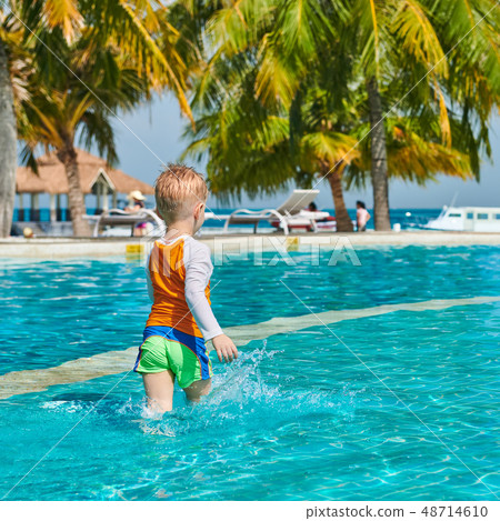 Toddler boy in resort swimming pool 48714610
