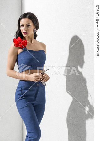 Brunette model in colorful clothing posing in studio 48716919