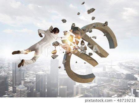 Woman attacking euro symbol 48719218