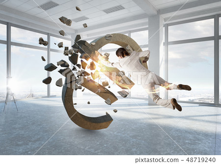 Woman attacking euro symbol Woman attacking euro symbol 48719240