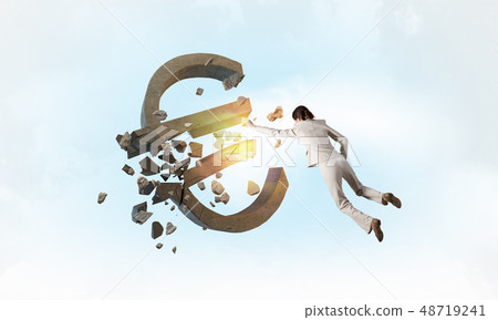 Woman attacking euro symbol Woman attacking euro symbol 48719241