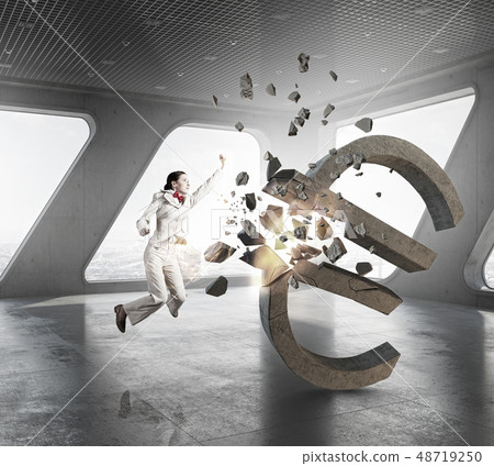 Woman attacking euro symbol Woman attacking euro symbol 48719250