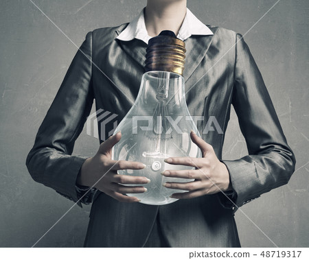Electric bulb in woman hand Electric bulb in woman hand 48719317