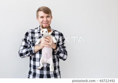 people, pets and animals concept - young man holding jack russell terrier puppy on white background people, pets and animals concept - young man holding jack russell terrier puppy on white background 48722492