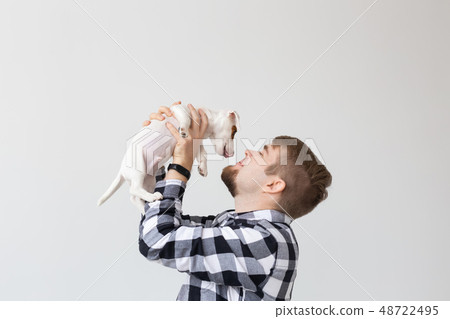 people, pets and animals concept - young man kissing jack russell terrier puppy on white background people, pets and animals concept - young man kissing jack russell terrier puppy on white background 48722495