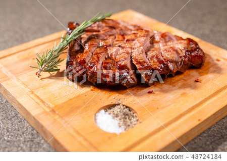 Food and horse meat concept - Roast meat on cutting board with cumin 48724184