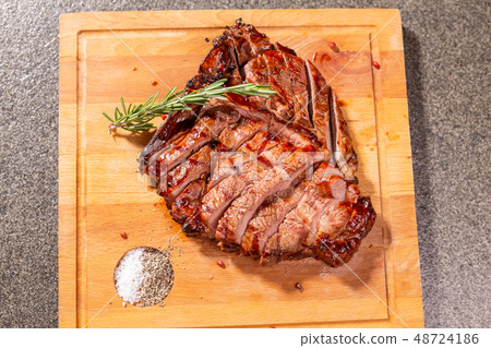 food, delicious and craft concept - cutting horse meat steak on wooden desk 48724186