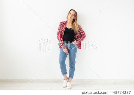 People and fashion concept - Full length image of woman posing sideways over white background 48724287
