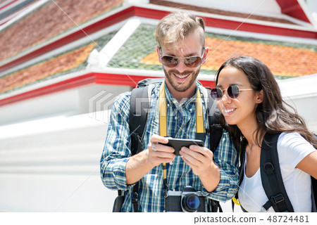 Tourist backpackers looking at smartphone screen 48724481