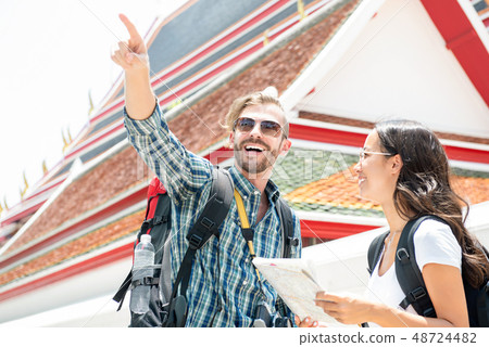 Tourist backpackers traveling in ancient Thai Tourist backpackers traveling in ancient Thai 48724482