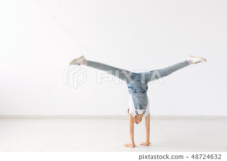 people, sport and children concept - pretty little girl doing gymnastics over white background people, sport and children concept - pretty little girl doing gymnastics over white background 48724632