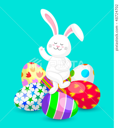 White rabbit sitting cross-legged on Easter eggs.  48724702