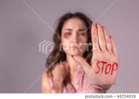 Domestic violence, protesting and people concept - brunette woman expressing denial with STOP on her Domestic violence, protesting and people concept - brunette woman expressing denial with STOP on her 48724839