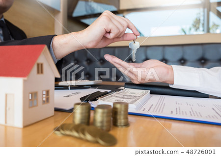 Real Estate developer Agent and sign on document giving keys of Real Estate developer Agent and sign on document giving keys of 48726001