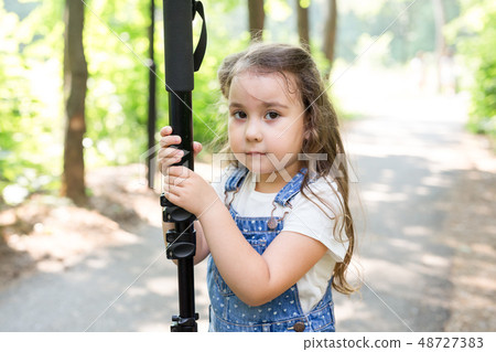 Hobby, profession, children and photographer concept - child with camera in forest Hobby, profession, children and photographer concept - child with camera in forest 48727383