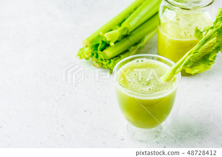 Green detox celery juice in a glass, copy space. 48728412