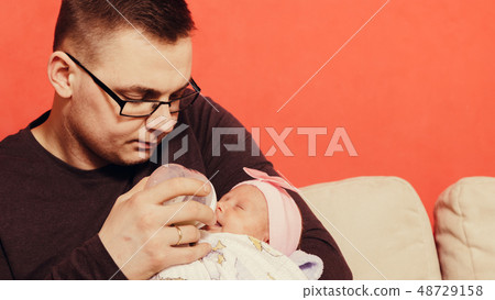 Father feeding from bottle newborn baby Father feeding from bottle newborn baby 48729158