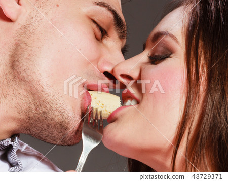 young couple eating banana fruit together young couple eating banana fruit together 48729371