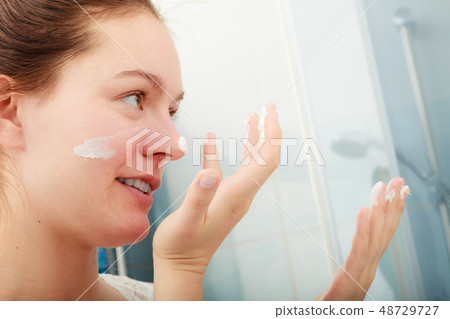 Woman applying moisturizing skin cream. Skincare. 48729727