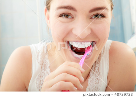 Woman brushing cleaning teeth. Oral hygiene. Woman brushing cleaning teeth. Oral hygiene. 48729728