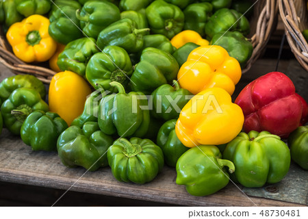 Green, red and yellow bell peppers at the market Green, red and yellow bell peppers at the market 48730481