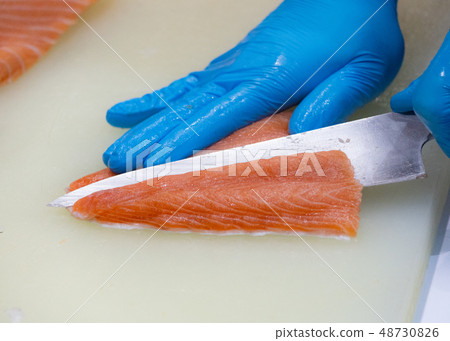 chef slicing raw fresh salmon, Chef preparing a chef slicing raw fresh salmon, Chef preparing a 48730826