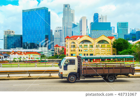 Truck on highway, Singapore cityscape 48731067