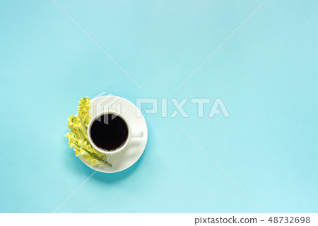 Cup of coffee and yellow wild flowers Cup of coffee and yellow wild flowers 48732698