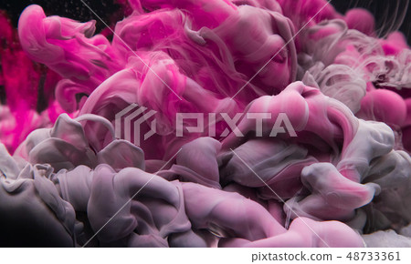 Coloured acrylic ink mixing in water on black Coloured acrylic ink mixing in water on black 48733361