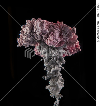 Coloured acrylic ink mixing in water on black 48733366