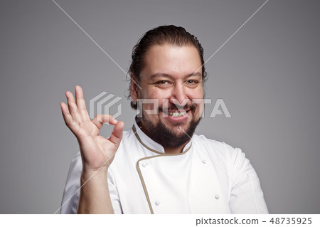 Pleased chef looking confidently at the camera 48735925