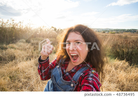 Travel, vacation and holiday concept - Happy young woman having fun taking selfie against background Travel, vacation and holiday concept - Happy young woman having fun taking selfie against background 48736495