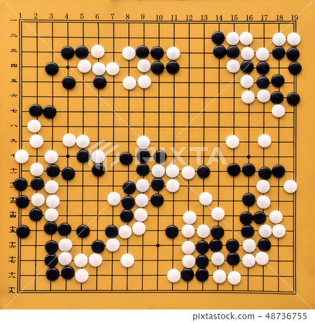 Top view on a Go board. Desk for board game Go and black and white bones. Traditional asian strategy Top view on a Go board. Desk for board game Go and black and white bones. Traditional asian strategy 48736755