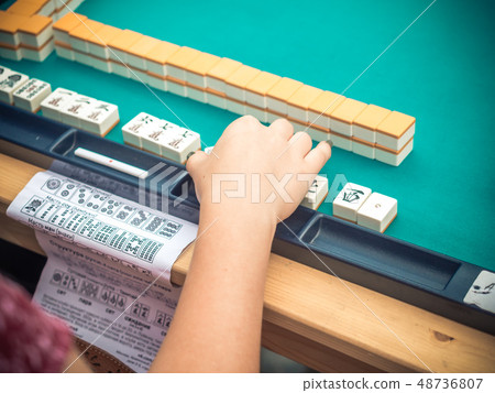 Japanese festival in Moscow. Young people playing mahjong asian tile-based game. Table gambling 48736807