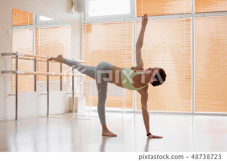 Young woman doing yoga on floor Young woman doing yoga on floor 48738723