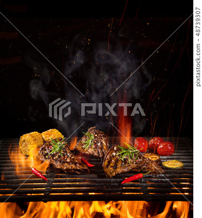 Beef steaks on the grill with flames 48739307