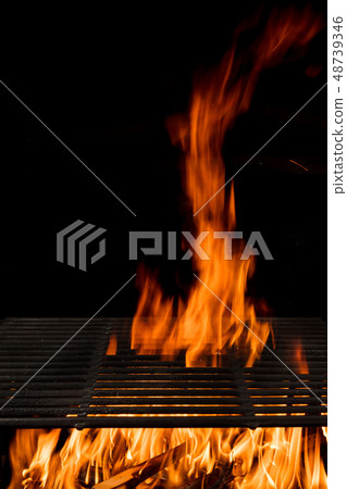 Empty flaming charcoal grill with open fire. Empty flaming charcoal grill with open fire. 48739346
