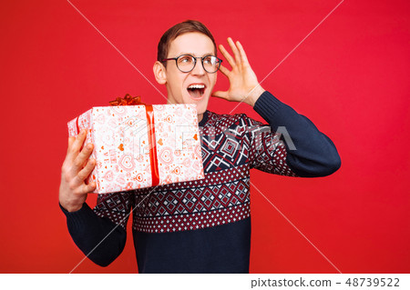 A man with glasses, a stunned guy with a gift 48739522