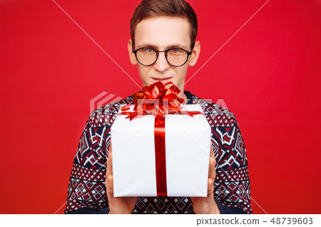 Stunned man in glasses, with a gift box Stunned man in glasses, with a gift box 48739603