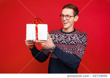Stunned man in glasses, with a gift box 48739606