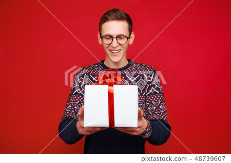 Portrait of a man with glasses, with a gift box 48739607