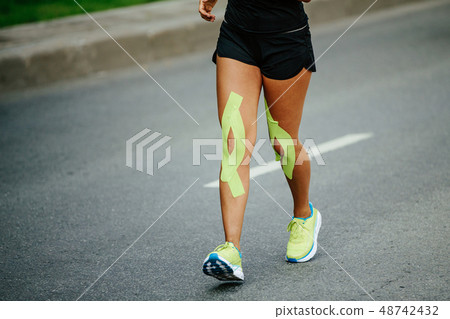 woman runner bright green kinesio tape woman runner bright green kinesio tape 48742432