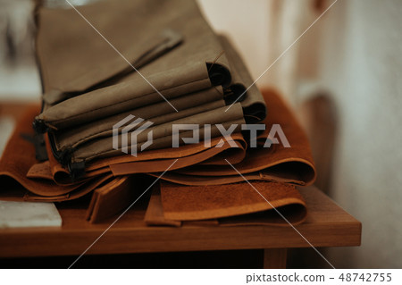 Leather craft or leather working. Selected pieces of beautifully colored or tanned leather on 48742755