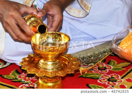 drop water to container for pray to dead people drop water to container for pray to dead people 48742835