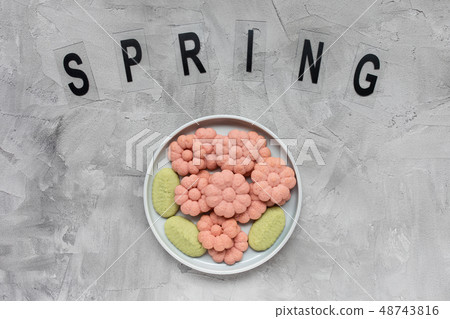 SPRING word and flower cookies on a plate 48743816